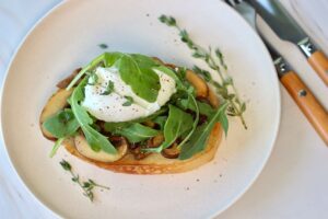 mushroom toast with poached egg and arugula